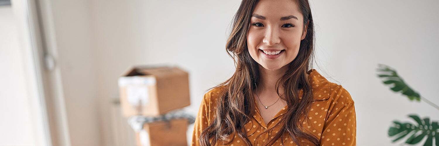 does getting rejected for a credit card affect your credit score? Woman in yellow stands in front of boxes